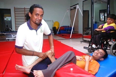 Physiotherapist Kiram Sam Raji (left) giving treatment to a patient