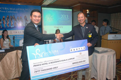 Prince Hotel director of sales Marcus Tioh present mock cheque to Robert Lo