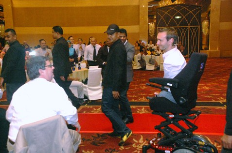 Nick Vujicic moves on his customised electric wheelchair.