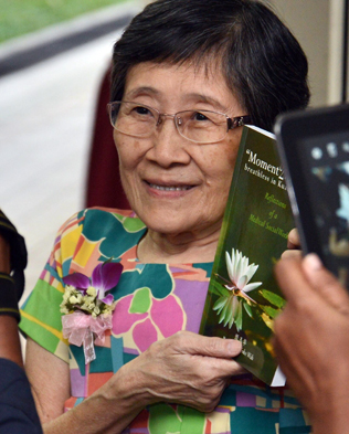 A beaming Barbara Yen showing her debut book