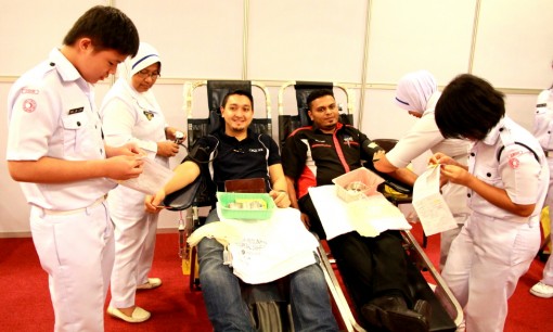 Two young men bravely donating their blood
