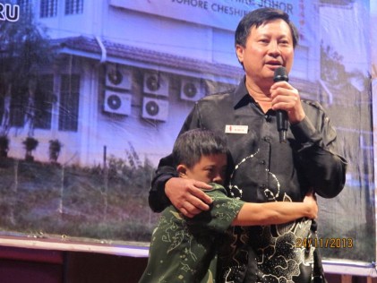 A 38-year old resident clings to Dr Ng when he speaks passionately about the Home