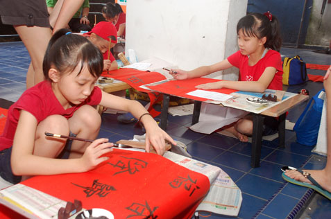 Children participating in calligraphy contest