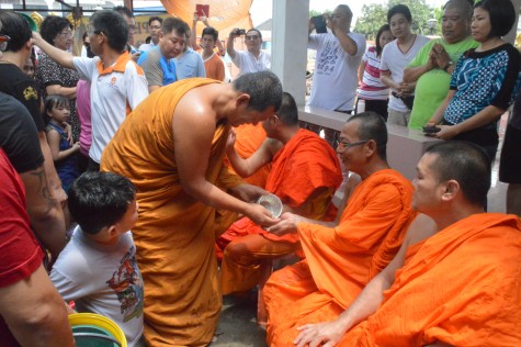 Monks join the fun as well, as they sprinkle water on each other