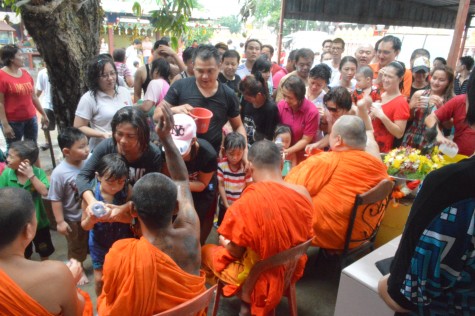 Devotees also taking turns to sprinkle onto the Monks