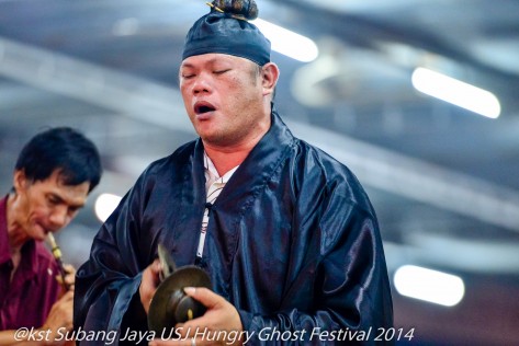 A Toaist priest chants to appease  the Hungry Ghosts