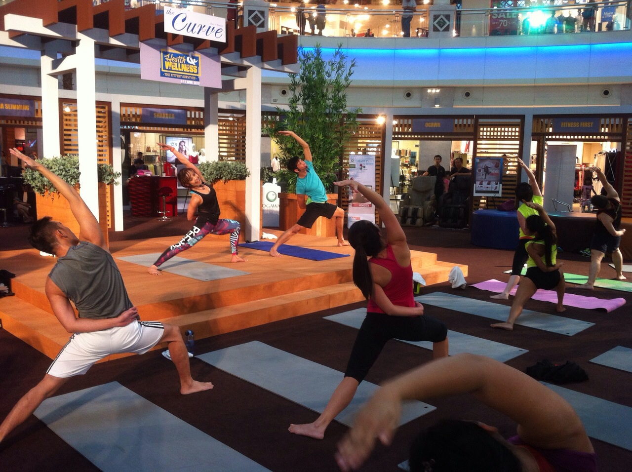 Fitness First instructors conducting a Body Balance class at the Curve's Centre Court.