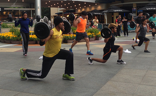 Participants working up a sweat with weights at the Piazza