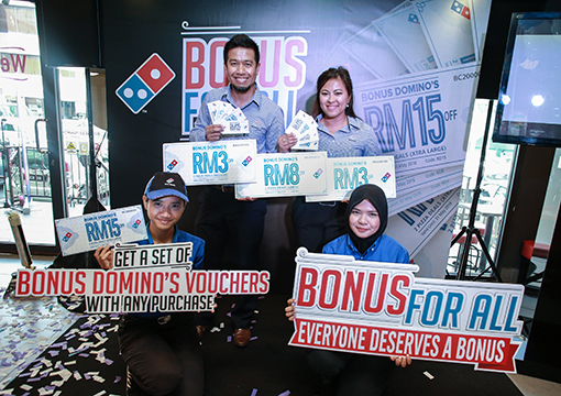 Presenting the Domino's Bonus for All vouchers at the launch event in Petaling Jaya, Selangor.