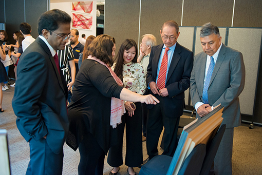 Chief Judge, Ms Elizabeth Cardosa (second from left) together with Dato’ Robert Cheim, Chairman of Tanjong plc (fourth from left) and Mr. Gerard Nathan, Group Chief Financial Officer of Tanjong plc (first from right) and Mr. M. Jayakumar, Senior General Manager, Group HR and Administrative Services of Tanjong plc (first from left) discuss the joint first prize winning piece for the Mixed Media category, titled ‘Children of Yesteryear’ with the winning artist Leow Xu Jia (middle) of ATEC Academy.