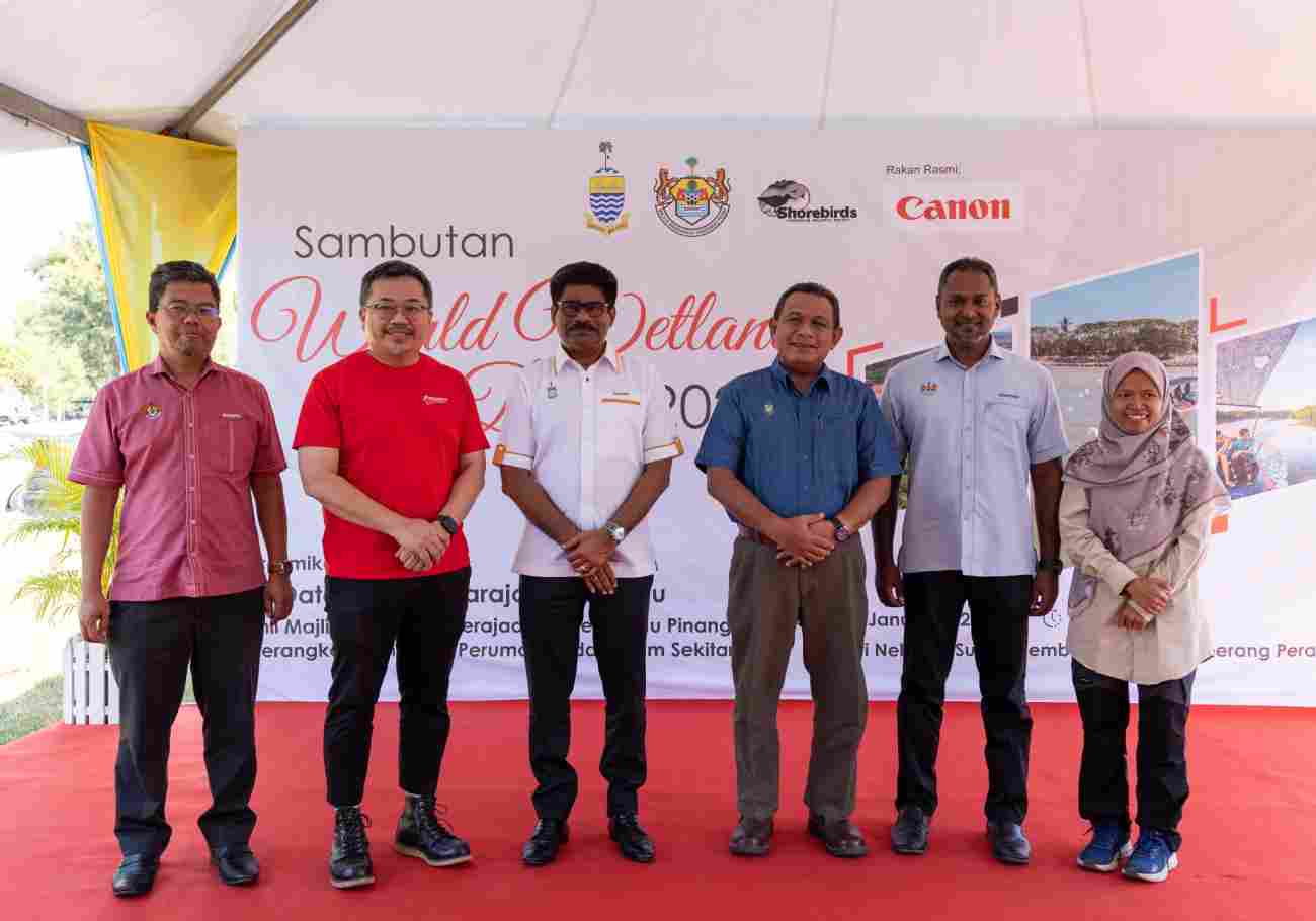 Diverse group participating in conservation activities at Sungai Tembus, symbolizing collaborative efforts for a sustainable future.