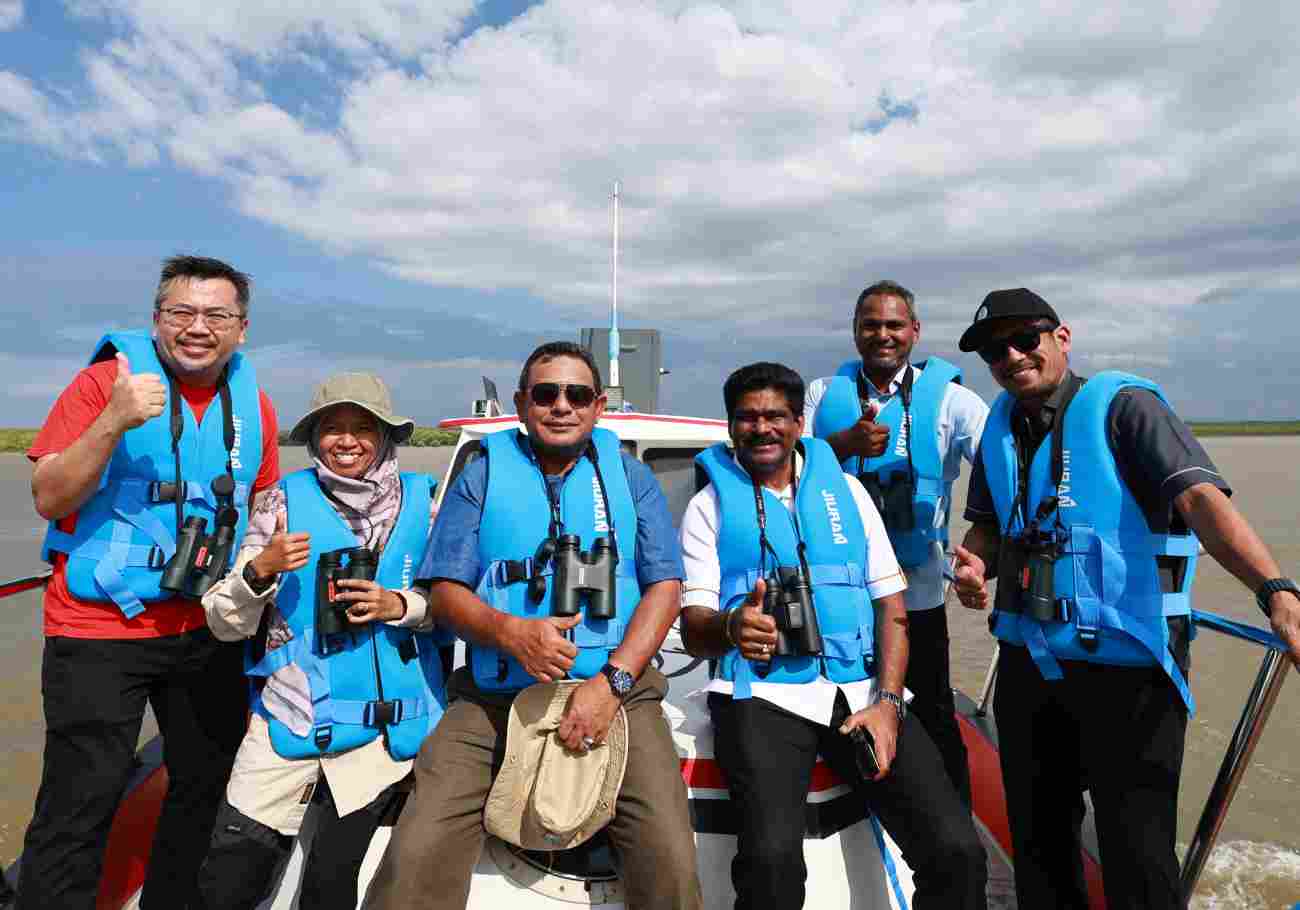 Group using Canon cameras for birding tour at Sungai Tembus, highlighting Canon's support for bird conservation.