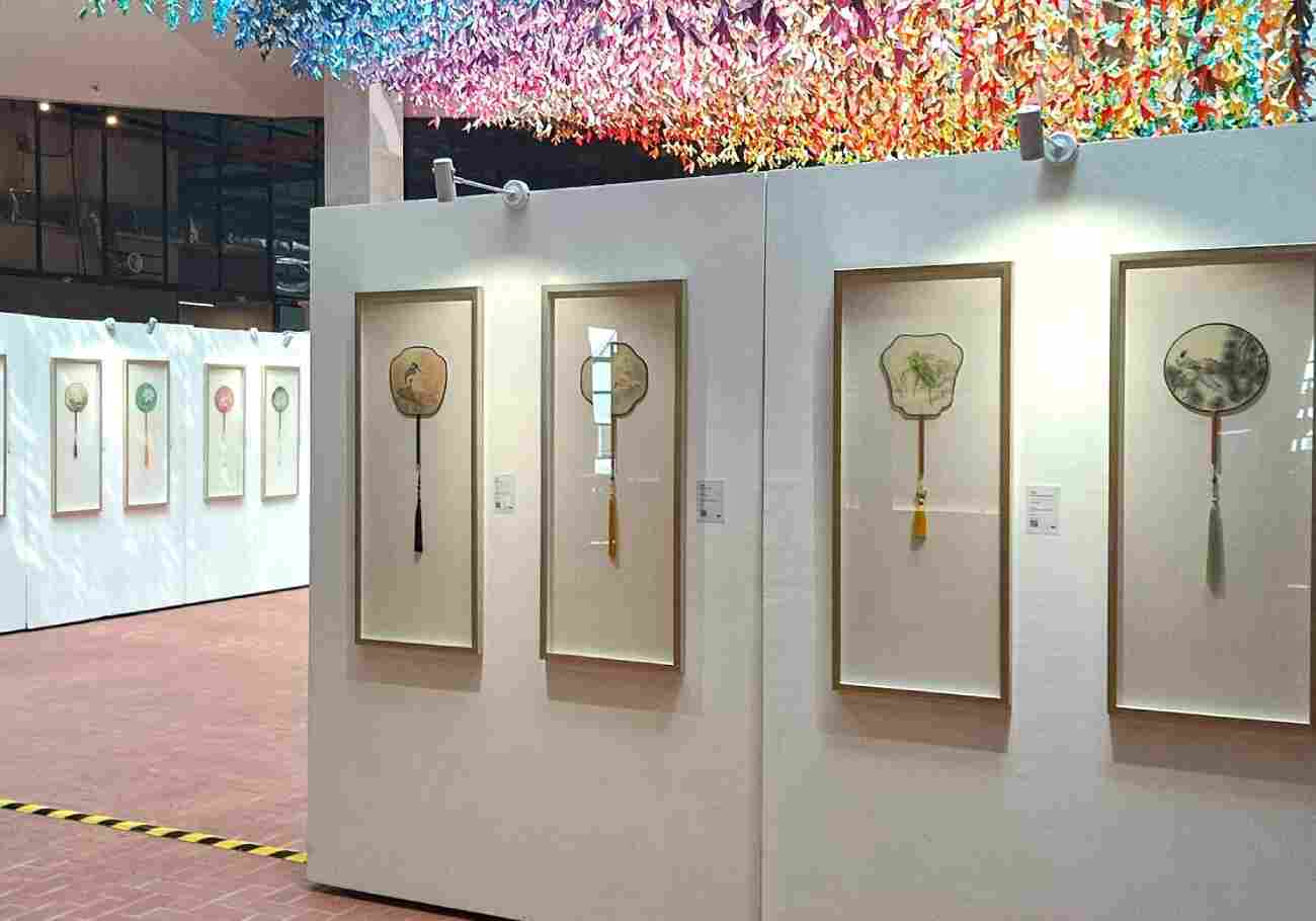 Panoramic view of the exhibition space at The LINC KL, showcasing multiple Gongbi Silk Fan artworks.
