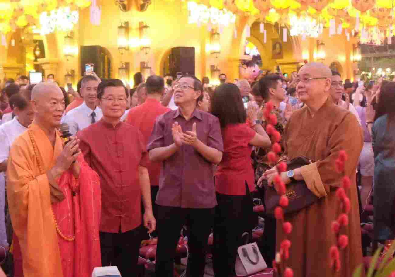 Dignitaries, Chief Minister Chow Kon Yeow at the  Kek Lok Si Temple illuminated with colorful neon lights and lanterns at night.
